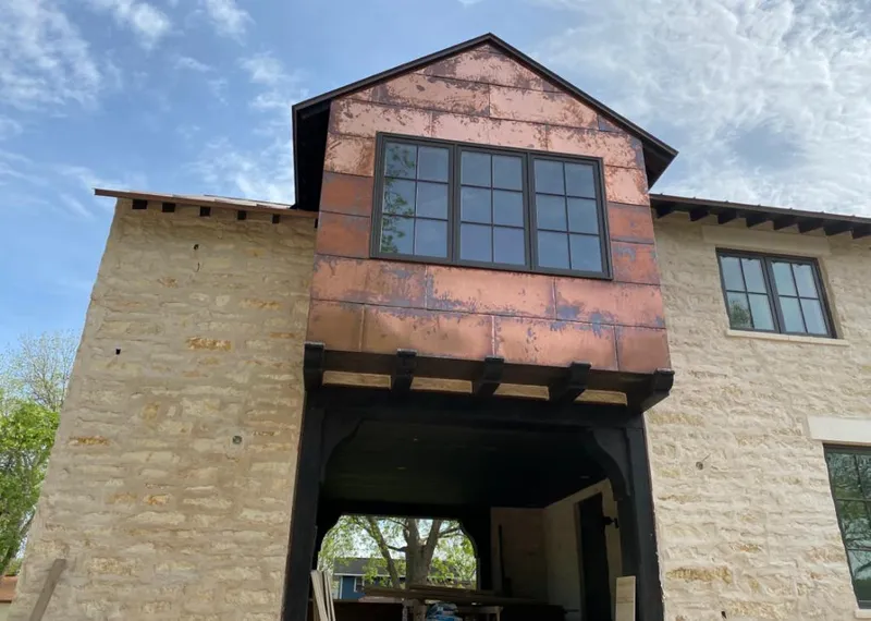 Copper metal panel facade on a stone building for Skylight Installation in Punta Gorda